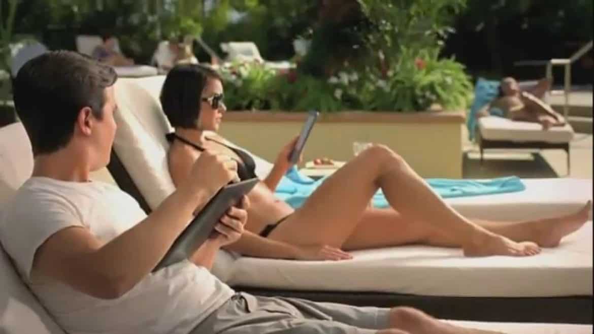 girl holding a e reader on sun bed