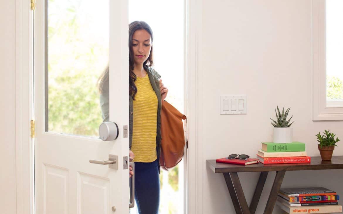 Woman Opening A Door With Smart Lock