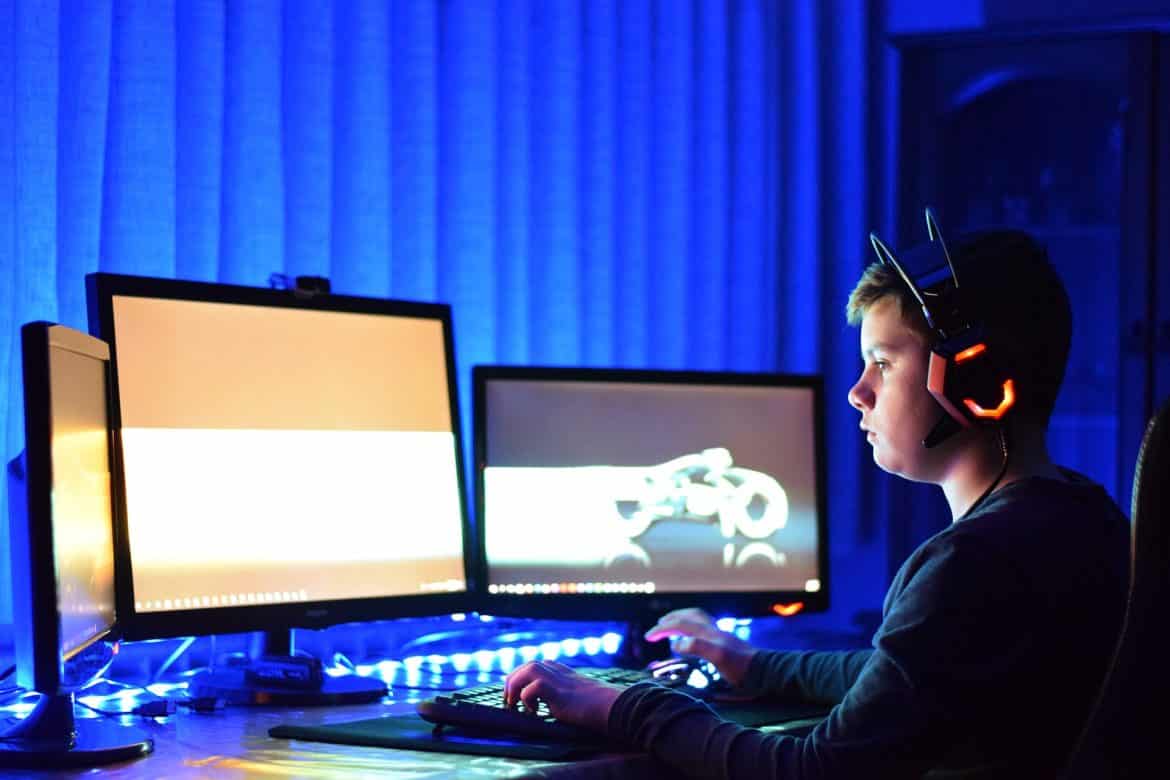 Child Playing Games On Monitor