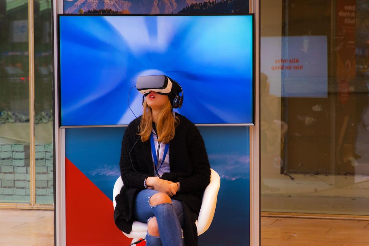 Girl Wearing An Occuls Rift 2014 marked the start of what has come to be known as the year when virtual reality (VR) hit the mainstream. Typically, the idea of any commodity becoming ‘mainstream’ should be backed with hard evidence data. As of summer, 2018, the unit shipments in the industry is estimated to have surpassed 5 million VR devices. It's crystal clear that the ‘wait and see’ approach that had been adopted by major manufacturers is shifting. Reason? None of them wants to be left out in this virtual gold rush. Unfortunately, just like in any other tech-based industry there will always be the risk of either getting in too late where a product is no longer hyped and has already been overthrown by something new. After all, the primary market for VR devices is the millennial age which has come to be known for its short attention spans (no offense to our dear ones). 1. virtual reality park and family entertainment center VR is promising to offer highly immersive experiences especially when it's well equipped with the right gear. This is already happening; numerous virtual reality park and family entertainment centers are popping up everywhere. These facilities offer VR experience as a service, and as such, they include various forms of customizations to fit every family member. The parks offer various activities from single player games to multiplayer roleplaying games which a whole family could participate in. This provides not only virtual reality business opportunities for the park owners but also increased demand for the game developers, hardware manufacturers, and distributors. It would be unfair to talk of virtual reality franchise without mentioning virtual reality arcade. This VR gaming industry is estimated will be worth $45 Billion in less than seven years. The reason behind this optimism lies on the fact that supporting gear used in VR games is nearly impossible to purchase, so enthusiasts opt to pay for the services at such VR arcades which are already well equipped and maintained. This is the way to go if you are interested in how to make money with virtual reality. Majority of the VR headsets in the market such as HTC Vive, Oculus Rift, and Sony PlayStation VR are already investing in gaming hardware. 2. virtual reality franchise and turnkey solution While VR in itself is not that much complicated, designing and implementing a VR system comprising of multiple VR stations is hectic. This is because most of the VR gear relies on specific custom-built computers that can render the high-quality immersive graphics required for VR to work. Secondly, there’s the whole issue with setting up sensors that enable room scale VR allowing you to move around and not just seat. As with any other challenge this one does present new opportunities for businesses that will offer virtual reality franchise. This requires them to come up with a detailed business plan that will not only be able to cater to the process of acquiring VR hardware but also how to run the entire business optimally. On the other hand, there is the opportunity for businesses that provide turnkey solutions. In such a scenario, an investor could outsource the setup process to a group of professionals whose primary job will be to acquire all the necessary hardware, make all necessary room design adjustments and install all of the required software’s. The final product will be a VR business that’s ready to go, and the owner will only need to turn the ‘key’ and get into business without having to worry about all of the technicalities involved in the setting up process. 3. virtual reality events and parties Gone are the days when a laid-back birthday party was enough, nowadays its no surprise to see commercial VR service providers being hired to host virtual reality events and parties. In this business model, the company invests in mobile VR headsets as well as supporting equipment such as computers and in some cases even bouncing castles. On getting a contract for a gig, the company will then proceed to the location and set up the equipment well before the party starts. During the party, the support crew will maintain the VR sets to ensure that each guest is enjoying the experience and also aid those that might need it. Of course, having a virtual reality events and parties hosting company will still require you to market it but if there’s one thing that gets a company’s popularity going is the customers’ hype. Its therefore recommended to ensure that you pull off each gig perfectly and have workers who are sociable, after all chances are that the next contract will be from a former client. 4. virtual reality attraction and simulator Virtual reality introduces the impressive ability to transport guests to about anywhere in the world. This coupled with the ever-growing number of VR-ready movies, documentaries and photography opens up the world to new possibilities. All you would need is the initial VR hardware for your VR attraction site and access to VR-ready material. Thankfully YouTube does offer a wide range of such videos and majority are copyright free. This even opens up new revenue avenues whereby one could generate VR ready video content and license it to these upcoming simulators. 5. virtual reality horror and quest rooms, roller coaster VR has introduced endless possibilities in just how we can utilize already existing fun activities. The best example would be the VR roller coaster which is just the traditional roller coaster which has been equipped with VR gear allowing the riders to enjoy highly immersive and wild rides. Adding VR to horror and quest rooms will increase the adrenaline rush associated with such gaming activities making them even more addictive. For a company to invest in such, they would need to have the initial room and capacity to integrate VR hardware to existing equipment. Conclusion If you were initially a skeptic of virtual reality and chose to wait and see where the industry would go, it's now high time you joined this lucrative market. The opportunities available are endless and can only be limited if we stop dreaming. Not only are existing franchises real proof of the successes happening in this industry but they are also in the frontline of the ever-growing innovations in it. Girl Wearing An Occuls Rift 2014 marked the start of what has come to be known as the year when virtual reality (VR) hit the mainstream. Typically, the idea of any commodity becoming ‘mainstream’ should be backed with hard evidence data. As of summer, 2018, the unit shipments in the industry is estimated to have surpassed 5 million VR devices. It's crystal clear that the ‘wait and see’ approach that had been adopted by major manufacturers is shifting. Reason? None of them wants to be left out in this virtual gold rush. Unfortunately, just like in any other tech-based industry there will always be the risk of either getting in too late where a product is no longer hyped and has already been overthrown by something new. After all, the primary market for VR devices is the millennial age which has come to be known for its short attention spans (no offense to our dear ones). 1. virtual reality park and family entertainment center VR is promising to offer highly immersive experiences especially when it's well equipped with the right gear. This is already happening; numerous virtual reality park and family entertainment centers are popping up everywhere. These facilities offer VR experience as a service, and as such, they include various forms of customizations to fit every family member. The parks offer various activities from single player games to multiplayer roleplaying games which a whole family could participate in. This provides not only virtual reality business opportunities for the park owners but also increased demand for the game developers, hardware manufacturers, and distributors. It would be unfair to talk of virtual reality franchise without mentioning virtual reality arcade. This VR gaming industry is estimated will be worth $45 Billion in less than seven years. The reason behind this optimism lies on the fact that supporting gear used in VR games is nearly impossible to purchase, so enthusiasts opt to pay for the services at such VR arcades which are already well equipped and maintained. This is the way to go if you are interested in how to make money with virtual reality. Majority of the VR headsets in the market such as HTC Vive, Oculus Rift, and Sony PlayStation VR are already investing in gaming hardware. 2. virtual reality franchise and turnkey solution While VR in itself is not that much complicated, designing and implementing a VR system comprising of multiple VR stations is hectic. This is because most of the VR gear relies on specific custom-built computers that can render the high-quality immersive graphics required for VR to work. Secondly, there’s the whole issue with setting up sensors that enable room scale VR allowing you to move around and not just seat. As with any other challenge this one does present new opportunities for businesses that will offer virtual reality franchise. This requires them to come up with a detailed business plan that will not only be able to cater to the process of acquiring VR hardware but also how to run the entire business optimally. On the other hand, there is the opportunity for businesses that provide turnkey solutions. In such a scenario, an investor could outsource the setup process to a group of professionals whose primary job will be to acquire all the necessary hardware, make all necessary room design adjustments and install all of the required software’s. The final product will be a VR business that’s ready to go, and the owner will only need to turn the ‘key’ and get into business without having to worry about all of the technicalities involved in the setting up process. 3. virtual reality events and parties Gone are the days when a laid-back birthday party was enough, nowadays its no surprise to see commercial VR service providers being hired to host virtual reality events and parties. In this business model, the company invests in mobile VR headsets as well as supporting equipment such as computers and in some cases even bouncing castles. On getting a contract for a gig, the company will then proceed to the location and set up the equipment well before the party starts. During the party, the support crew will maintain the VR sets to ensure that each guest is enjoying the experience and also aid those that might need it. Of course, having a virtual reality events and parties hosting company will still require you to market it but if there’s one thing that gets a company’s popularity going is the customers’ hype. Its therefore recommended to ensure that you pull off each gig perfectly and have workers who are sociable, after all chances are that the next contract will be from a former client. 4. virtual reality attraction and simulator Virtual reality introduces the impressive ability to transport guests to about anywhere in the world. This coupled with the ever-growing number of VR-ready movies, documentaries and photography opens up the world to new possibilities. All you would need is the initial VR hardware for your VR attraction site and access to VR-ready material. Thankfully YouTube does offer a wide range of such videos and majority are copyright free. This even opens up new revenue avenues whereby one could generate VR ready video content and license it to these upcoming simulators. 5. virtual reality horror and quest rooms, roller coaster VR has introduced endless possibilities in just how we can utilize already existing fun activities. The best example would be the VR roller coaster which is just the traditional roller coaster which has been equipped with VR gear allowing the riders to enjoy highly immersive and wild rides. Adding VR to horror and quest rooms will increase the adrenaline rush associated with such gaming activities making them even more addictive. For a company to invest in such, they would need to have the initial room and capacity to integrate VR hardware to existing equipment. Conclusion If you were initially a skeptic of virtual reality and chose to wait and see where the industry would go, it's now high time you joined this lucrative market. The opportunities available are endless and can only be limited if we stop dreaming. Not only are existing franchises real proof of the successes happening in this industry but they are also in the frontline of the ever-growing innovations in it.