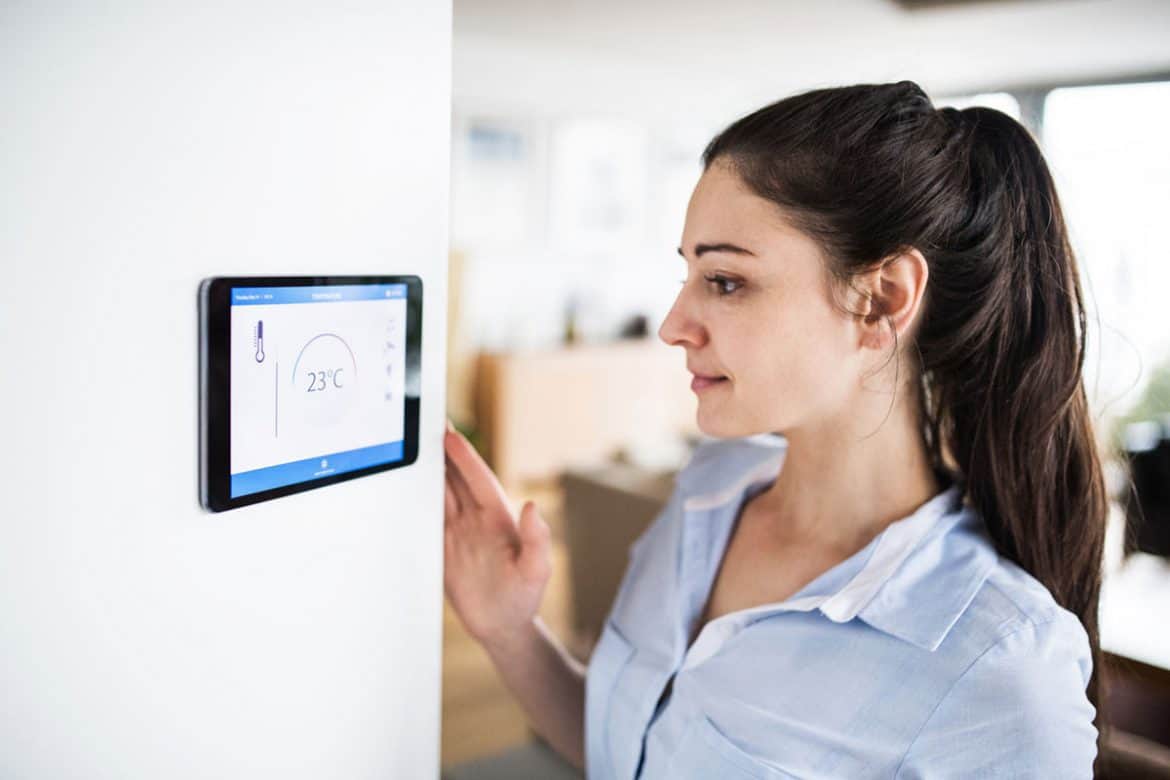 Girl Adjusting A Best Smart Thermostat