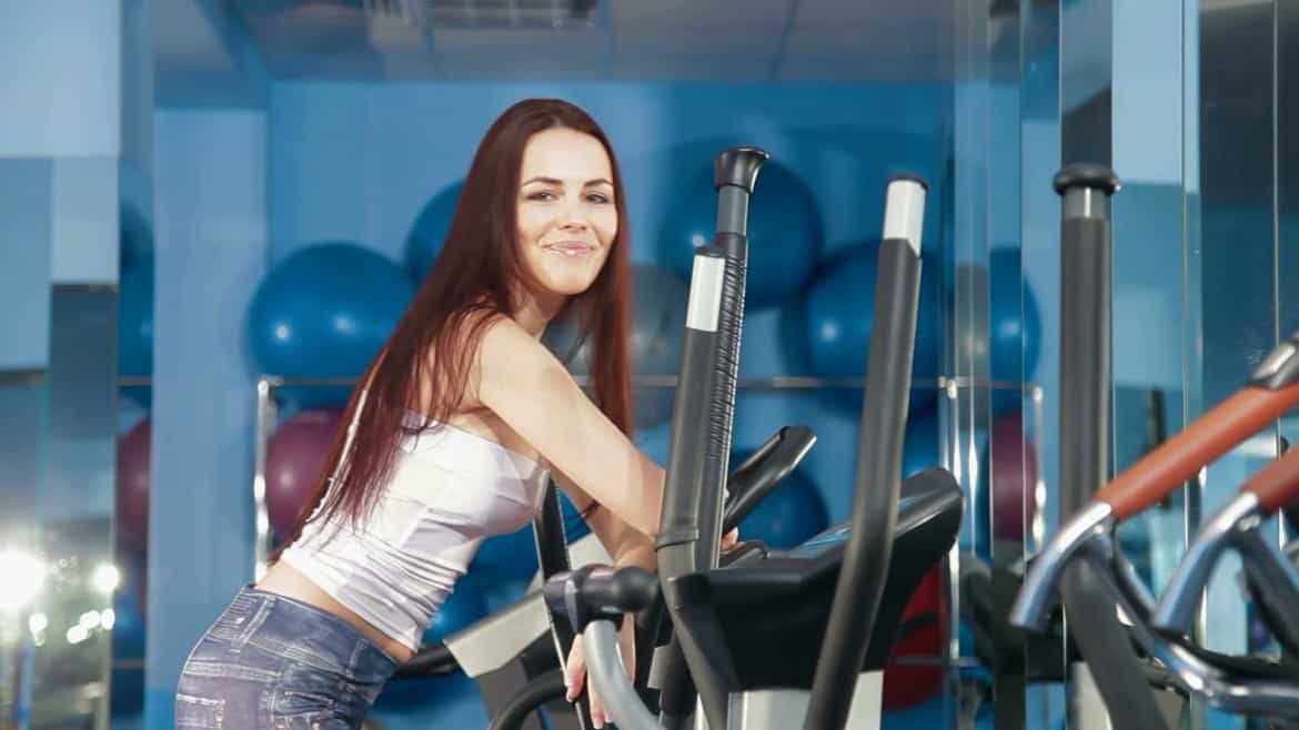 young woman on a elliptical trainer