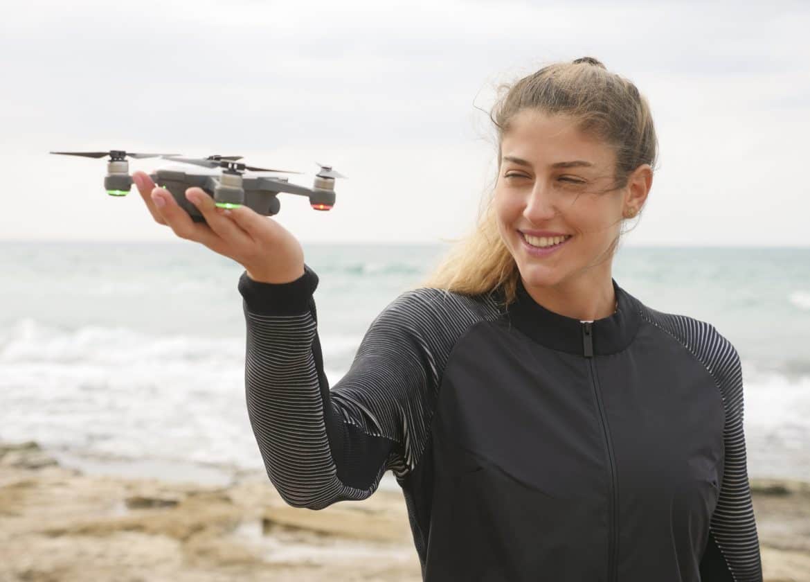 Young woman holding a selfie drone