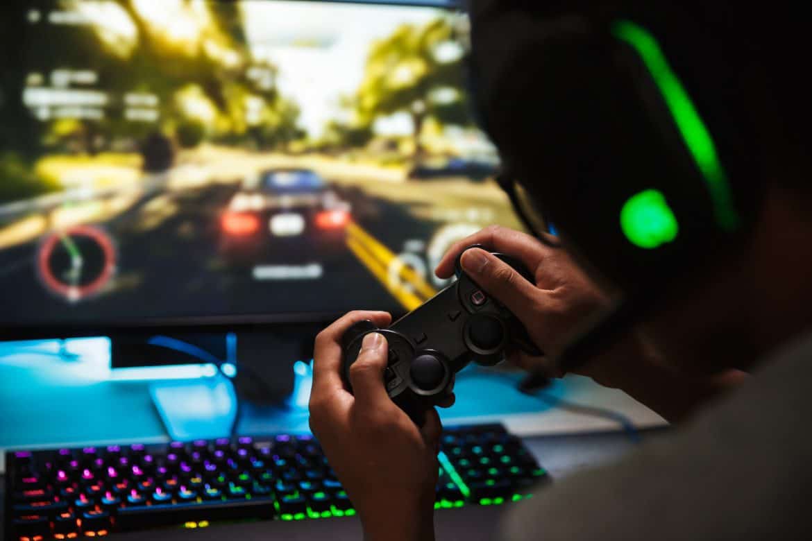Photo closeup of teenage gamer guy playing video games online on