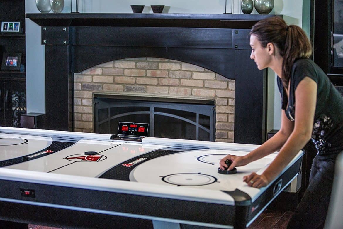 Woman Playing On Air Hockey table