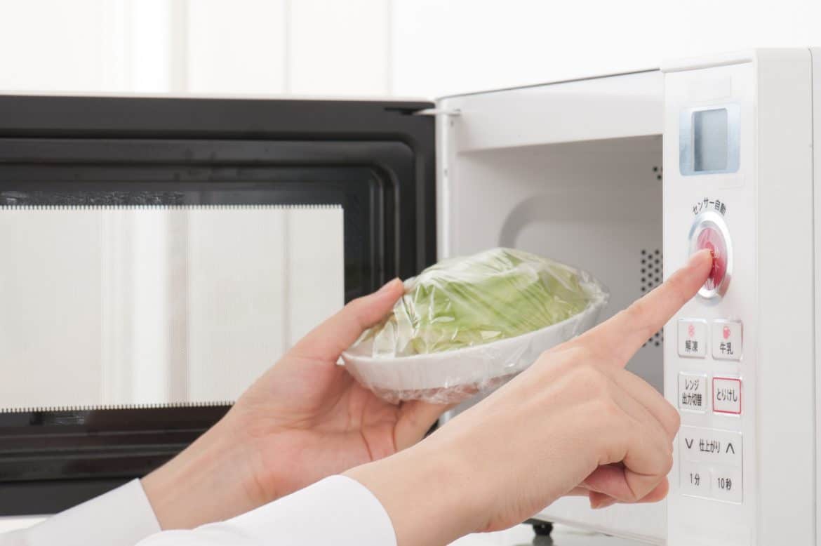 Woman Using Over The Range Microwave