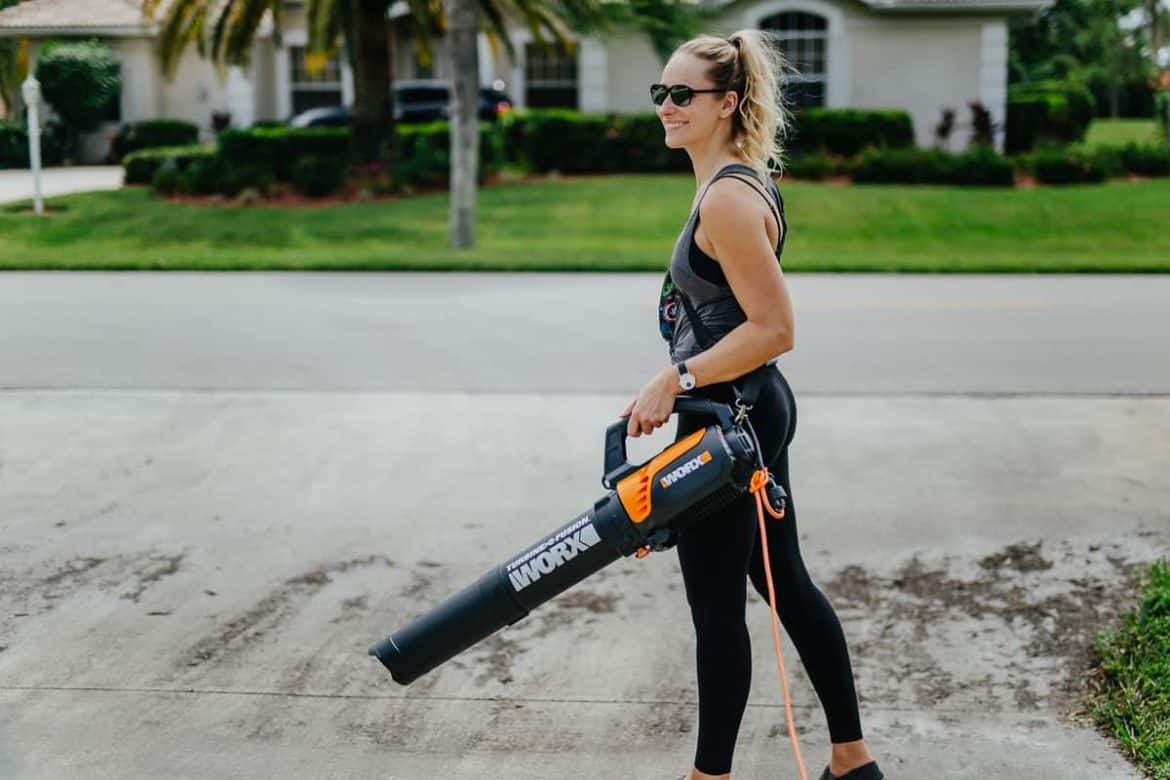 Woman with a leaf blower in hand