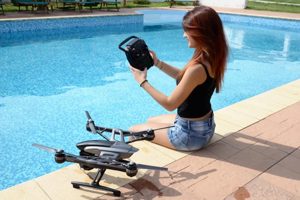 Girl With Drone Near A Pool