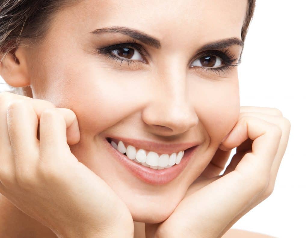 woman after electric toothbrush cleaning woman after electric toothbrush cleaning