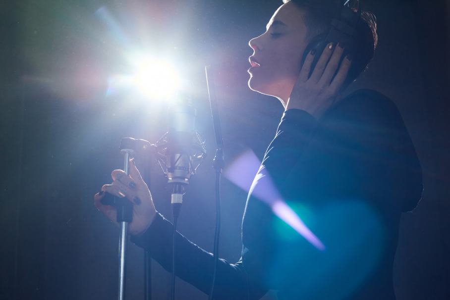 woman singing into a BLUE microphone snowball