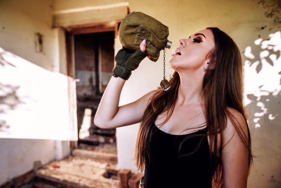 girl drinking from a top flask